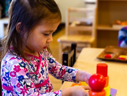 Confident Girl in Montessori Classroom