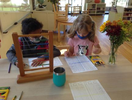Children solving Math problems with an abacus at Lifetime Montessori Elementary school
