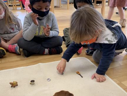 Toddlers in a Montessori classroom playing with small objects