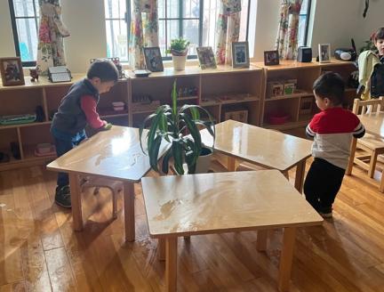 Children Cleaning their Tables in a Montessori Classroom