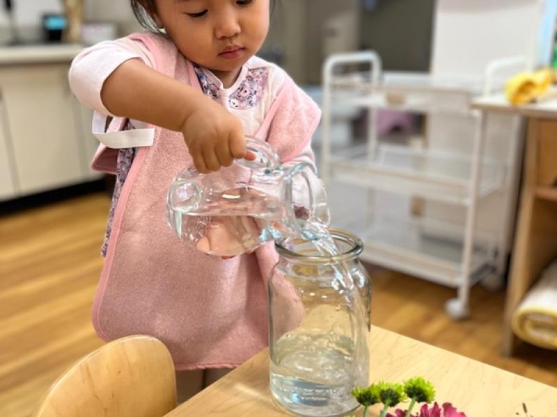 Toddler doing it 'all by myself cutting plants independently.