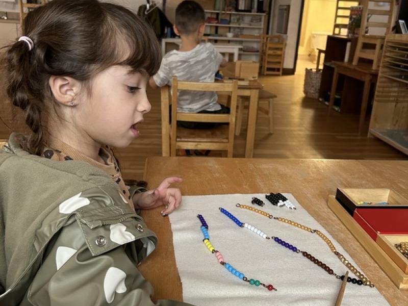 Montessori math uses beads to help children learn basic math concepts, including numbers, operations, and the decimal system