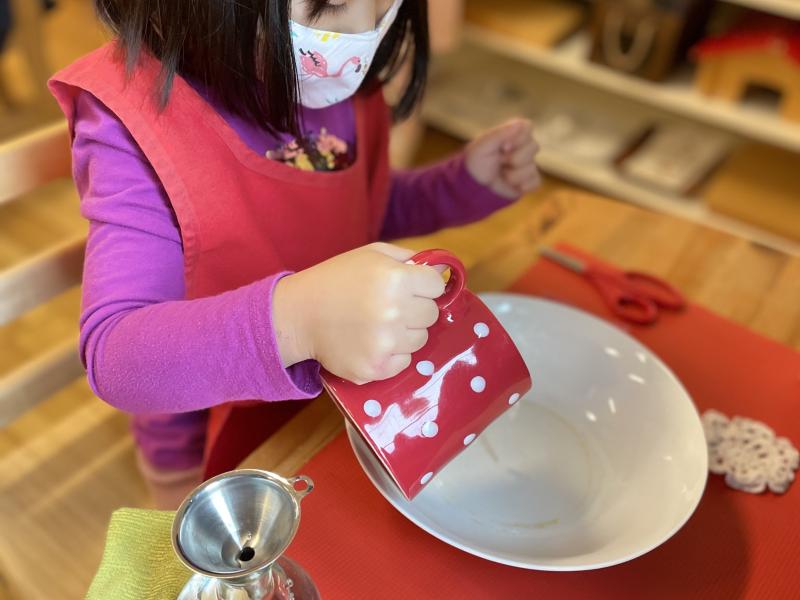 Child cutting fruit independently at Lifetime Montessori school in Santaluz