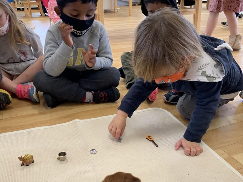 Toddlers in a Montessori classroom playing with small objects