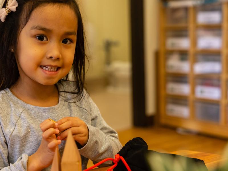 Happy girl in a Montessori preschool in San Diego