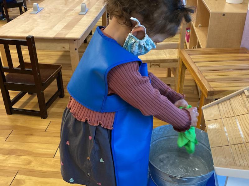 Child doing chores builds their self esteem at Lifetime Montessori school
