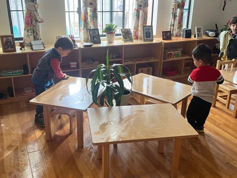 Children Cleaning their Tables in a Montessori Classroom