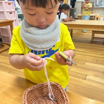 Toddler using a lock and key at Lifetime Montessori School