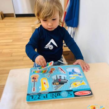 Toddler independently learning shapes and puzzles at Lifetime Montessori School 
