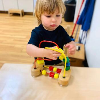 Toddler independently learning shapes and puzzles at Lifetime Montessori School 