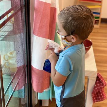 Toddler independently working to keep classroom clean at Lifetime Montessori School 